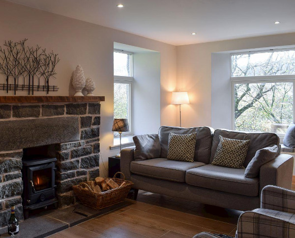 The living room, with a wood burning stove, at Craigmuick Cottage in Aberfoyle