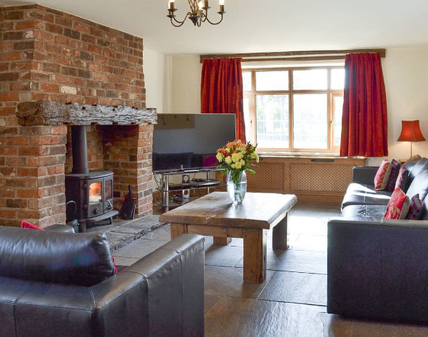 The living room with a wood burning stove at Scraggs Cottage near Cheddleton