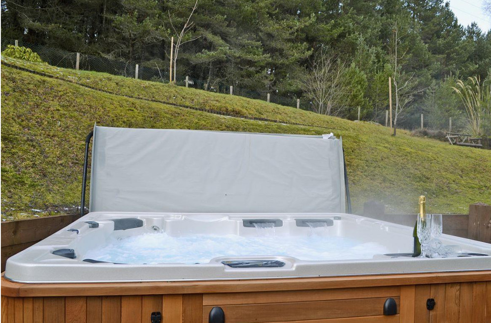 Relax in the outdoor hot tub at Wildwood in Boat of Garten, near Aviemore