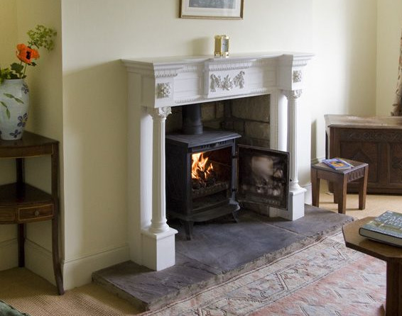 The living room with a wood burning stove at York House in Hudswell